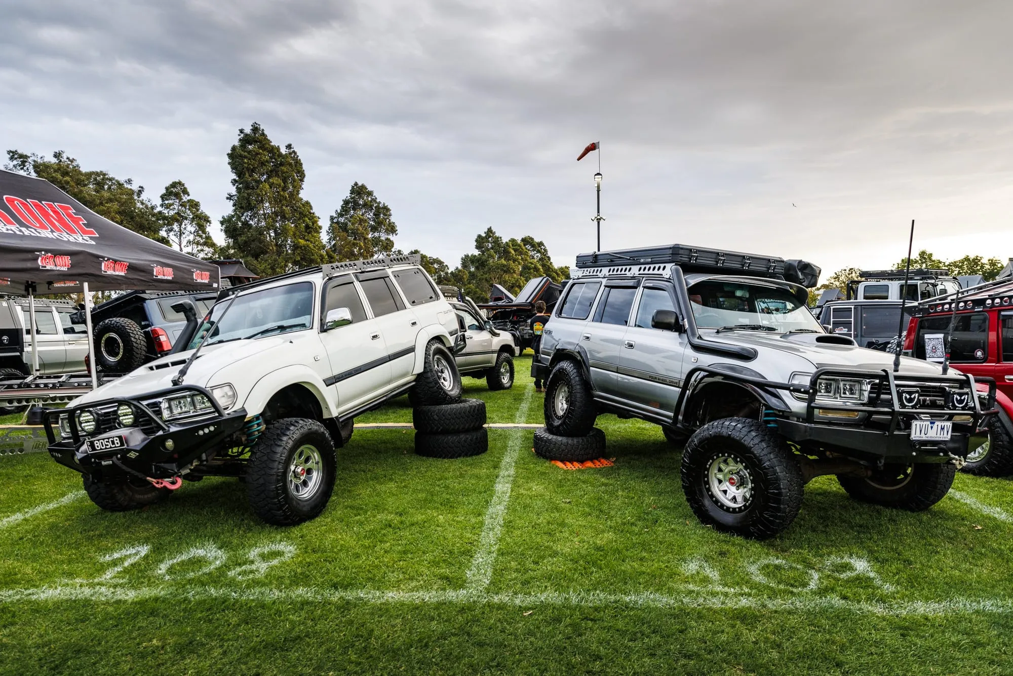 Modified 4x4 wagons lined up on the lawn at MotorEx