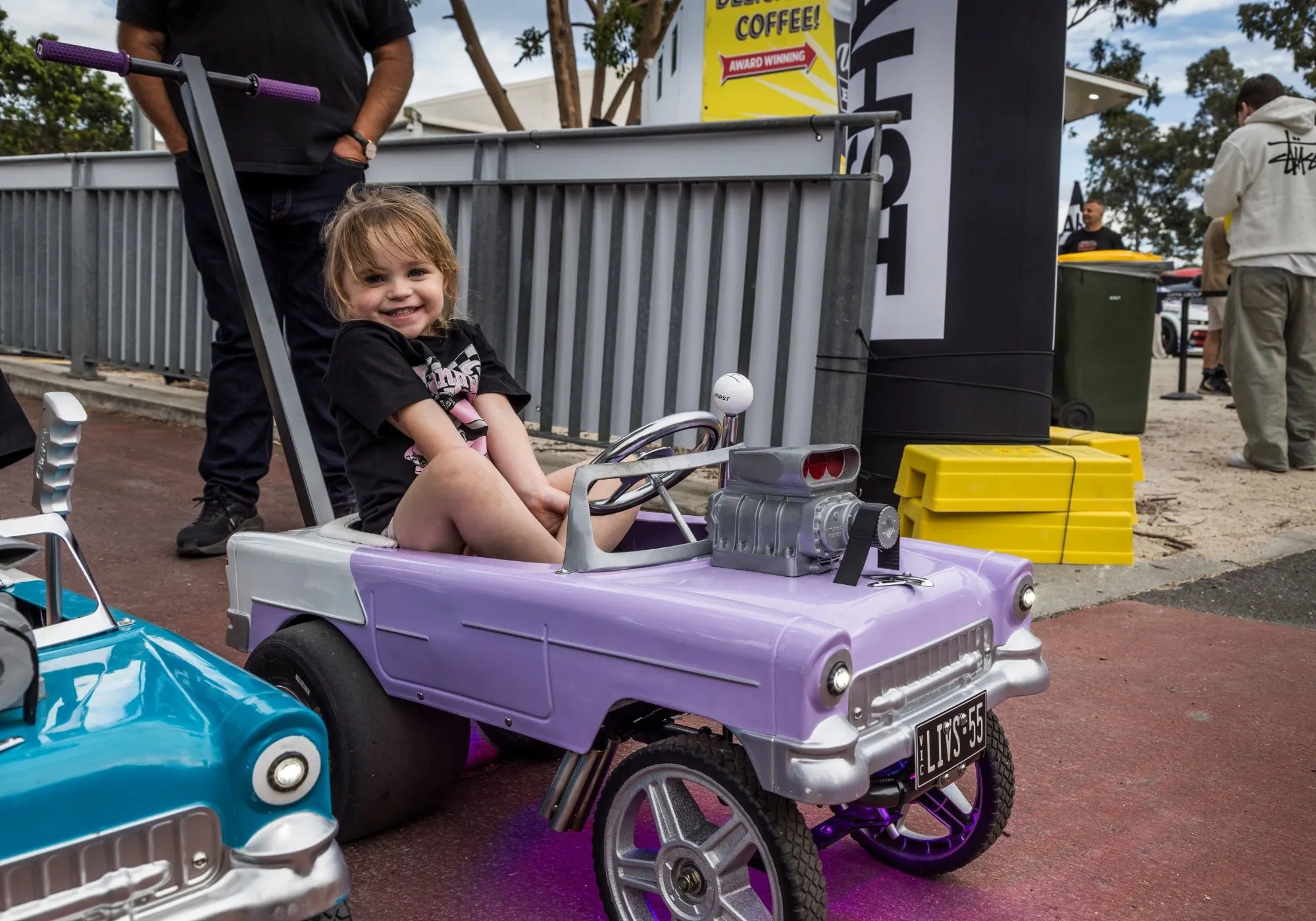 A young fan driving a pedal car at MotorEx